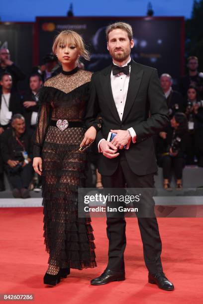 Margaret Zhang wearing a Jaeger-LeCoultre watch and a guest walk the red carpet ahead of the 'Three Billboards Outside Ebbing, Missouri' screening...