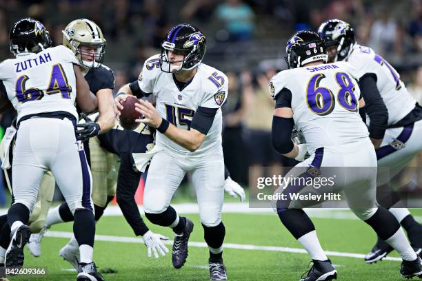 Ryan Mallett of the Baltimore Ravens scrambles to avoid the rush during a preseason game against the New Orleans Saints at Mercedes-Benz Superdome on...