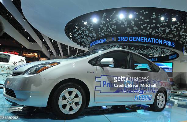 The side of a Toyota Prius Plug-In Hybrid vehicle is displayed on the show floor during the second press preview day at the Detroit International...