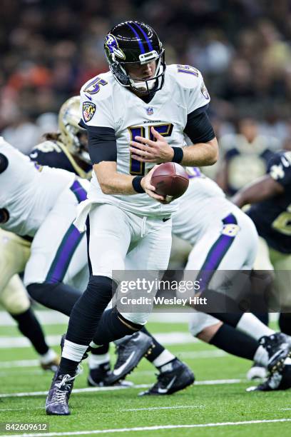 Ryan Mallett of the Baltimore Ravens drops back to make a handoff during a preseason game against the New Orleans Saints at Mercedes-Benz Superdome...