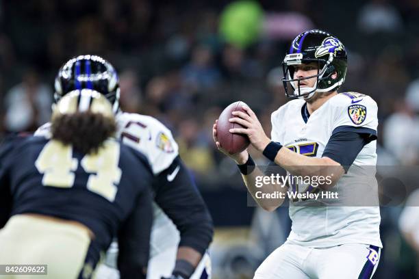 Ryan Mallett of the Baltimore Ravens catches the snap during a preseason game against the New Orleans Saints at Mercedes-Benz Superdome on August 31,...