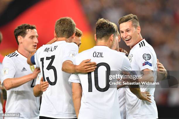 Julian Draxler of Germany celebrates with Mesut Oezil of Germany and Thomas Mueller of Germany after he scored to make it 2:0 during the FIFA 2018...