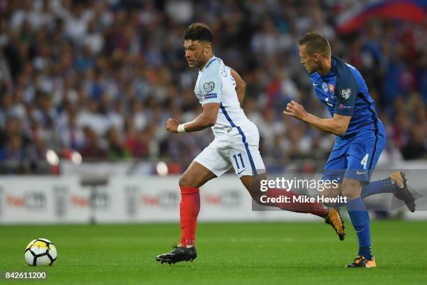 Alex Oxlade-Chamberlain of England is chased by Jan Durica of Slovakia during the FIFA 2018 World Cup Qualifier between England and Slovakia at...