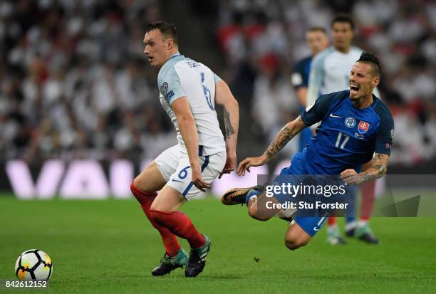 Phil Jones of England challenges Marek Hamsik of Slovakia during the FIFA 2018 World Cup Qualifier between England and Slovakia at Wembley Stadium on...