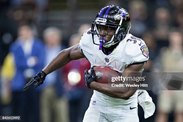 Bobby Rainey of the Baltimore Ravens runs the ball during a preseason game against the New Orleans Saints at Mercedes-Benz Superdome on August 31,...