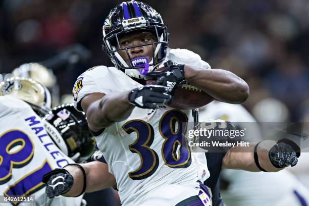 Bobby Rainey of the Baltimore Ravens runs the ball during a preseason game against the New Orleans Saints at Mercedes-Benz Superdome on August 31,...