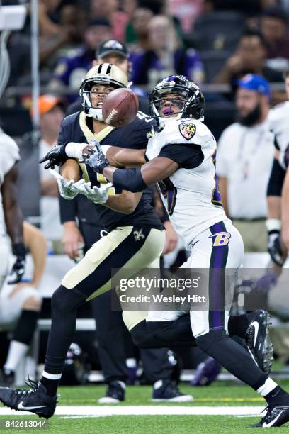 Corey Fuller of the New Orleans Saints has the pas knocked away by Marion Humphrey of the Baltimore Ravens at Mercedes-Benz Superdome on August 31,...