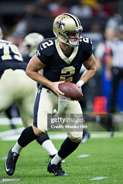 Ryan Nassib of the New Orleans Saints prepares to make a hand off during a preseason game against the Baltimore Ravens at Mercedes-Benz Superdome on...