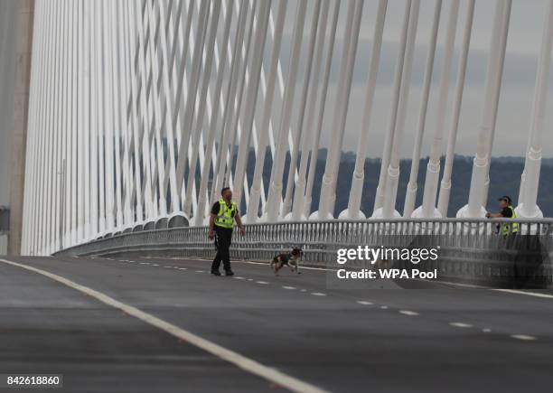 Police officers with sniffer dogs check the Queensferry Crossing ahead of the official opening of the new bridge across the Firth of Forth on...