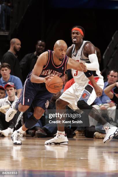 Jarvis Hayes of the New Jersey Nets moves the ball against Gerald Wallacae of the Charlotte Bobcats during the game at Time Warner Cable Arena on...