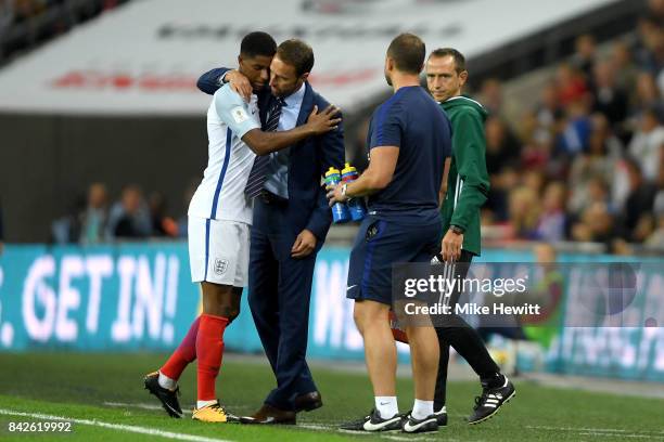 Marcus Rashford of England is embraced by Gareth Southgate manager of England as he is substituted during the FIFA 2018 World Cup Qualifier between...