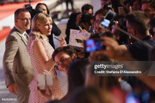 Kirsten Dunst from the movie 'Woodshock' signs autographs during the red carpet ahead of the 'Three Billboards Outside Ebbing, Missouri' screening...