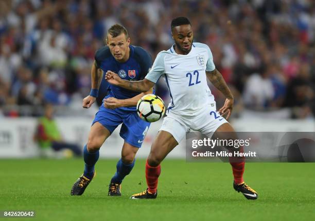 Raheem Sterling of England and Jan Durica of Slovakia battle for the ball during the FIFA 2018 World Cup Qualifier between England and Slovakia at...