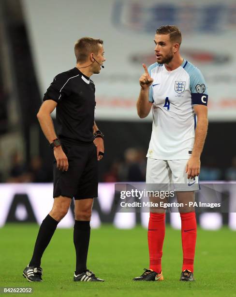 England's Jordan Henderson speaks with match referee Clement Turpin during the 2018 FIFA World Cup Qualifying, Group F match at Wembley Stadium,...