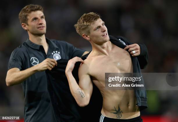 Thomas Mueller of Germany is seen with Toni Kroos of Germany after winning the FIFA 2018 World Cup Qualifier between Germany and Norway at...