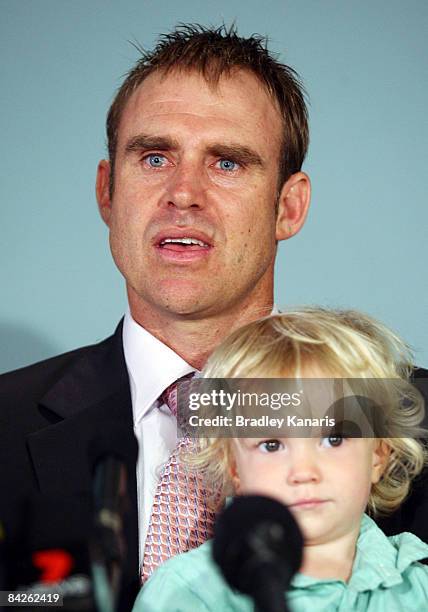 Matthew Hayden holds his son Thomas as he addresses the media at a press conference announcing his retirement from international cricket at the Gabba...