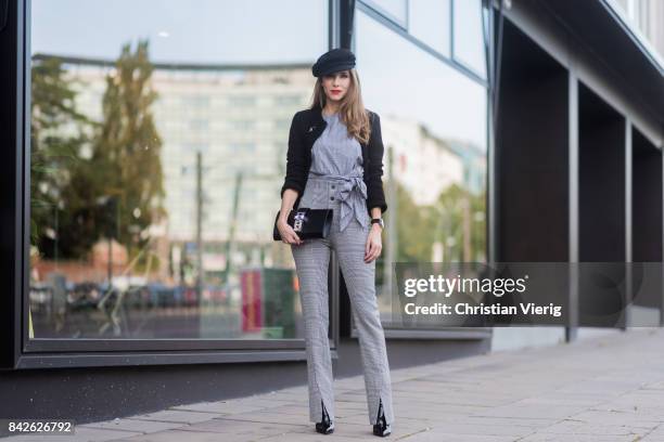 Alexandra Lapp wearing grey checked top and checked high waist pants by Zara, flat cap hat from Chanel, Tweed little black jacket in black from...