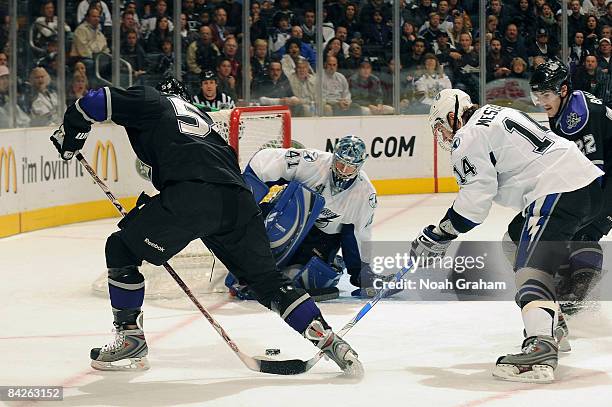 Mike Smith and Andrej Meszaros of the Tampa Bay Lightning defend the net against Teddy Purcell of the Los Angeles Kings during the game on January...