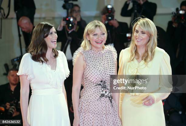 Kate Mulleavy, Kirsten Dunst and Laura Mulleavy walk the red carpet ahead of the 'Woodshock' screening during the 74th Venice Film Festival in...