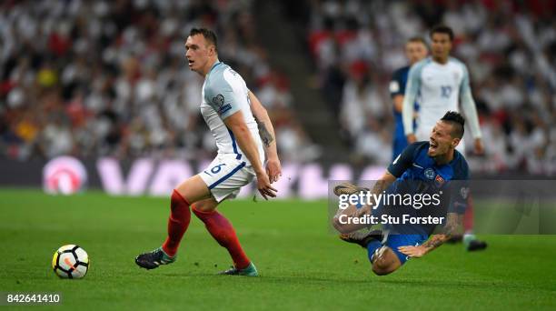 Phil Jones of England challenges Marek Hamsik of Slovakia during the FIFA 2018 World Cup Qualifier between England and Slovakia at Wembley Stadium on...