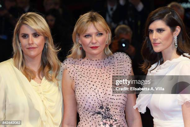 Kate Mulleavy, Kirsten Dunst and Laura Mulleavy walk the red carpet ahead of the 'Woodshock' screening during the 74th Venice Film Festival at Sala...