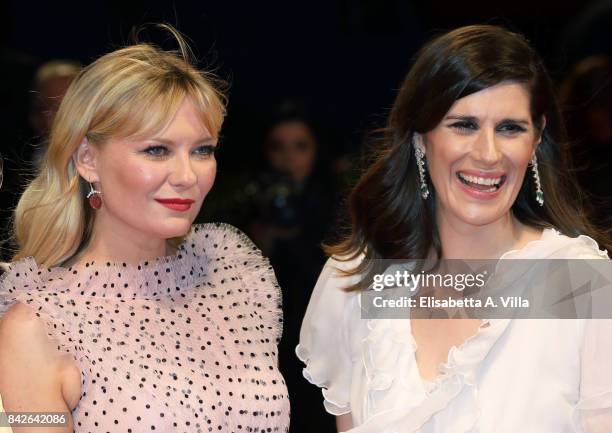 Kirsten Dunst and Laura Mulleavy walk the red carpet ahead of the 'Woodshock' screening during the 74th Venice Film Festival at Sala Giardino on...