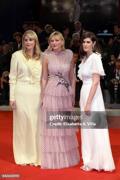 Kate Mulleavy, Kirsten Dunst and Laura Mulleavy walk the red carpet ahead of the 'Woodshock' screening during the 74th Venice Film Festival at Sala...