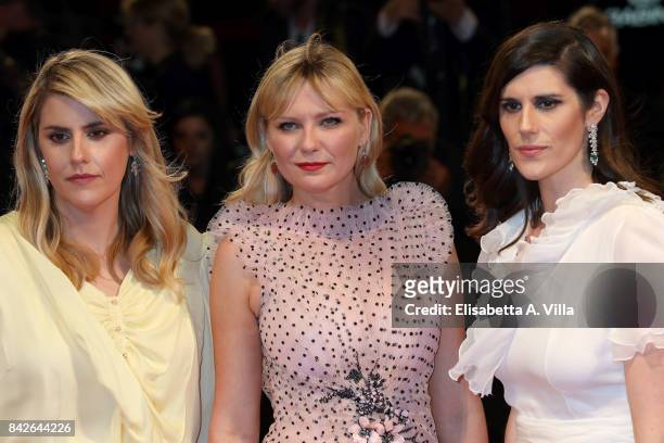 Kate Mulleavy, Kirsten Dunst and Laura Mulleavy walk the red carpet ahead of the 'Woodshock' screening during the 74th Venice Film Festival at Sala...