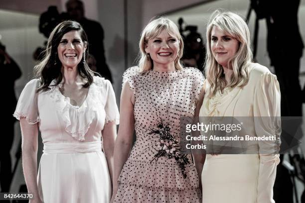 Kate Mulleavy, Kirsten Dunst and Laura Mulleavy walk the red carpet ahead of the 'TWoodshock' screening during the 74th Venice Film Festival at Sala...