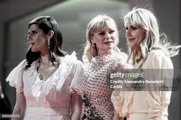 Kate Mulleavy, Kirsten Dunst and Laura Mulleavy walk the red carpet ahead of the 'TWoodshock' screening during the 74th Venice Film Festival at Sala...