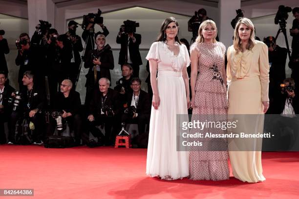 Kate Mulleavy, Kirsten Dunst and Laura Mulleavy walk the red carpet ahead of the 'TWoodshock' screening during the 74th Venice Film Festival at Sala...