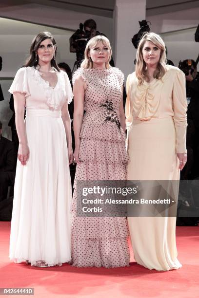 Kate Mulleavy, Kirsten Dunst and Laura Mulleavy walk the red carpet ahead of the 'TWoodshock' screening during the 74th Venice Film Festival at Sala...