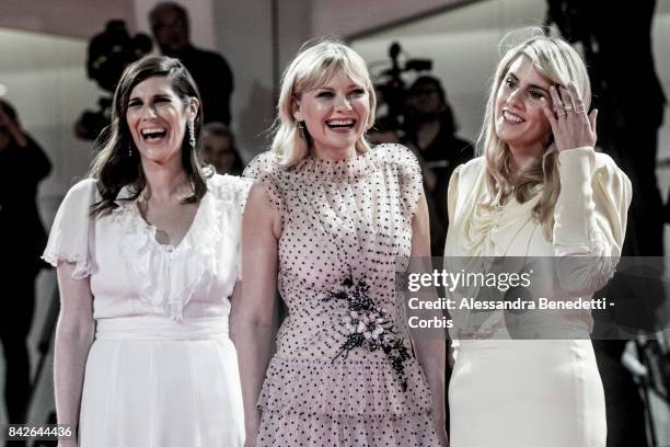 Kate Mulleavy, Kirsten Dunst and Laura Mulleavy walk the red carpet ahead of the 'TWoodshock' screening during the 74th Venice Film Festival at Sala...