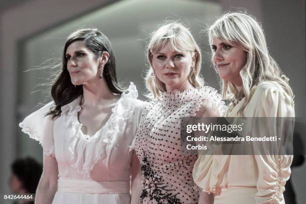 Kate Mulleavy, Kirsten Dunst and Laura Mulleavy walk the red carpet ahead of the 'TWoodshock' screening during the 74th Venice Film Festival at Sala...