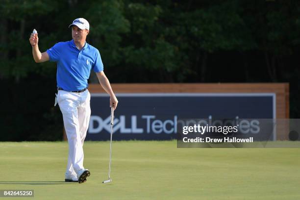 Justin Thomas of the United States waves to the crowd after making par on the 18th green to win the Dell Technologies Championship at TPC Boston on...