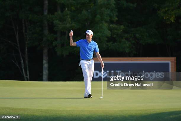 Justin Thomas of the United States waves to the crowd after making a putt for par on the 18th green to win the Dell Technologies Championship at TPC...