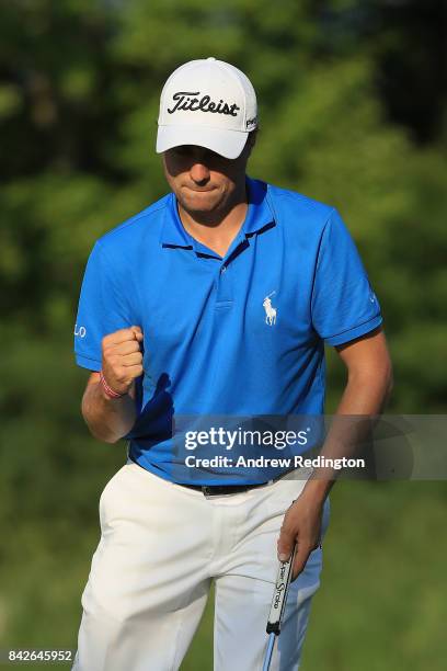 Justin Thomas of the United States reacts after making a putt for par on the 16th green during the final round of the Dell Technologies Championship...