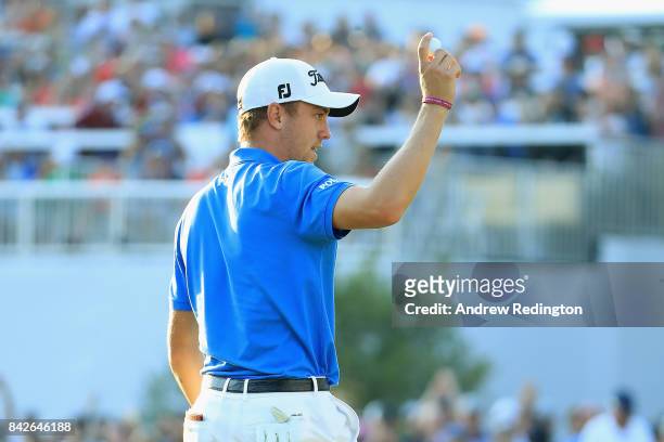 Justin Thomas of the United States waves to the crowd after making a putt for par on the 18th green to win the Dell Technologies Championship at TPC...