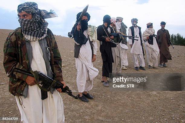In this picture taken on September 26 Fighters with Afghanistan's Taliban militia stand on a hillside at Maydan Shahr in Wardak province, west of...
