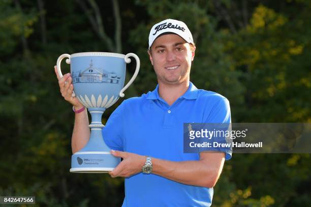 Justin Thomas of the United States poses with the trophy after winning the Dell Technologies Championship at TPC Boston on September 4, 2017 in...