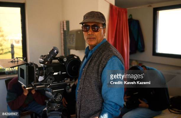 Iranian film director Abbas Kiarostami during a location shoot, 1st October 1996.
