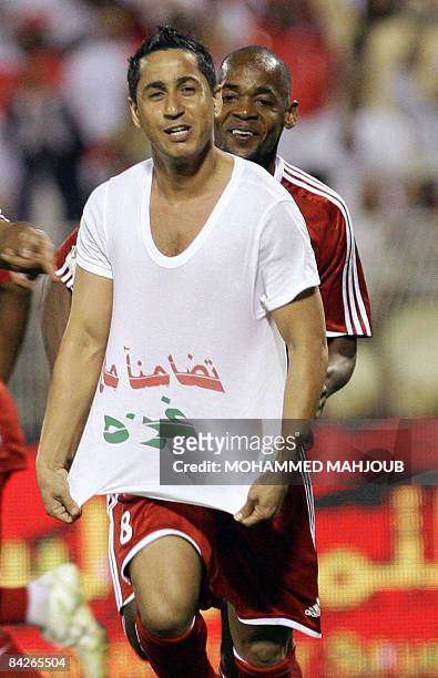 Omani player Bader al-Maymani, shows his tee-shirt reading 'in solidarity with Gaza', after scoring a goal against Bahrain during their 19th Gulf Cup...