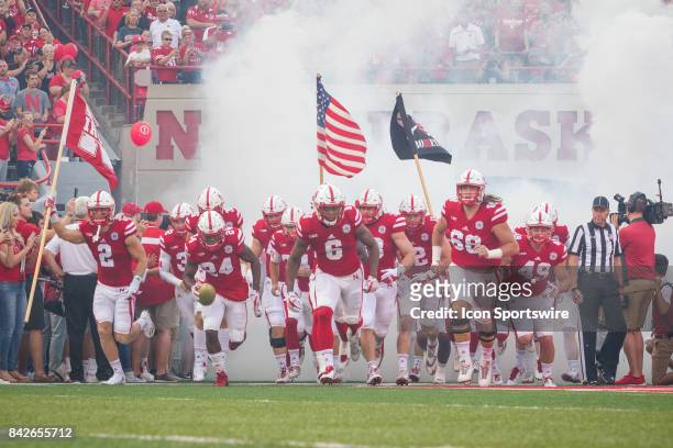 Nebraska Cornhuskers run out on to the field before the game against the Arkansas State Red Wolves on September 02, 2017 at Memorial Stadium in...