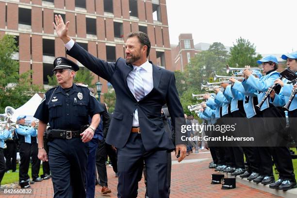 Fans greet head coach Larry Fedora of the North Carolina Tar Heels during their game against the California Golden Bears at Kenan Stadium on...