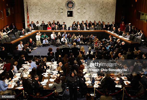 Secretary of State-designate and U.S. Senator Hillary Clinton prepares to testify before a packed room during her confirmation hearing before the...