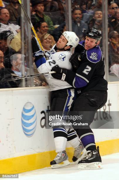 Martin St. Louis of the Tampa Bay Lightning is pinned to the boards by Matt Greene of the Los Angeles Kings during the game on January 12, 2009 at...