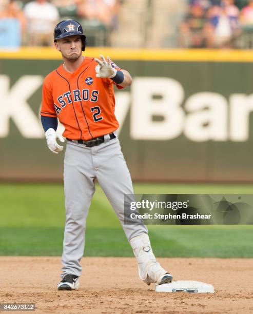 Alex Bregman of the Houston Astros gestures toward the dugout after hitting a two-run double off of relief pitcher Nick Vincent of the Seattle...