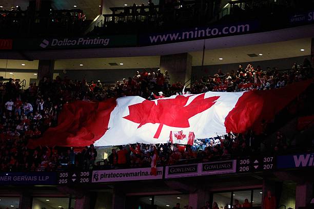 Giant Canadian flag travels through the crowd during pre-game ceremonies before the game featuring Team Canada versus Team Czech Republic at the IIHF...