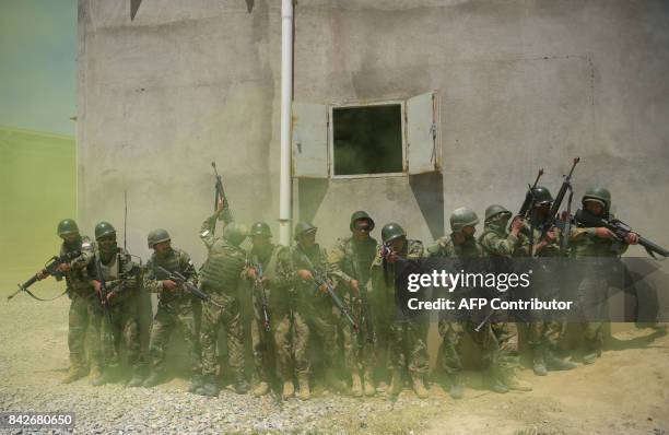 In this photograph taken on May 1 Afghan National Army soldiers train at the Kabul Military training centre on the outskirts of Kabul. Fresh recruits...