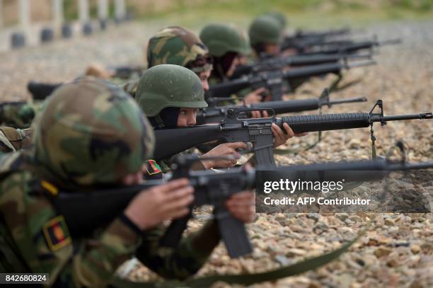 In this photograph taken on May 1 Afghan National Army female soldiers shoot their rifles during a live firing exercise at the Kabul Military...